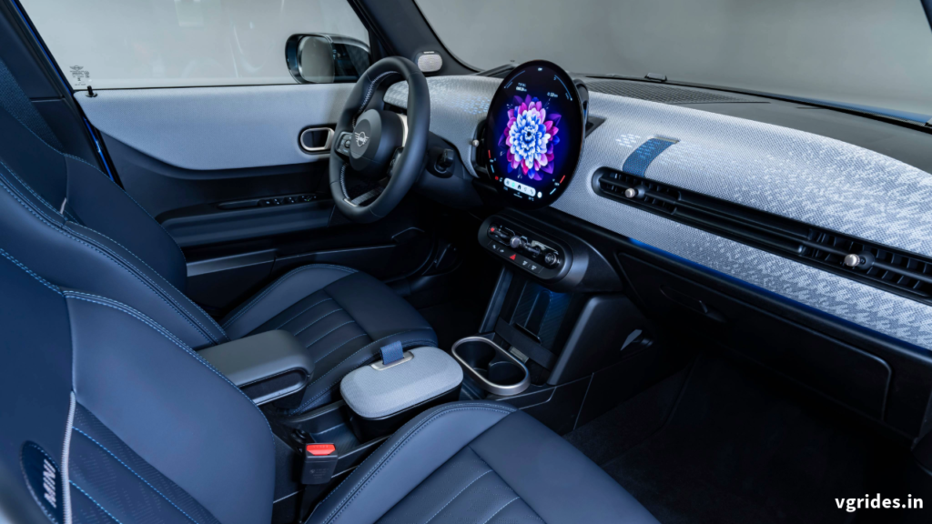 It is a rounded very bright OLED touchscreen infotainment system with Mini operating system 9 which can be operated by touch or voice. The operating system is easy to use and very smooth operations with navigation, media, phone, and other apps are available on the center display.