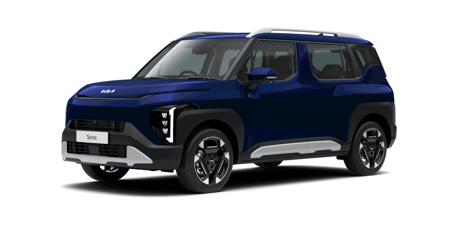 A sleek and modern KIA Syros SUV parked on a scenic Greek coastline, showcasing its elegant curved front design and boxy rear.