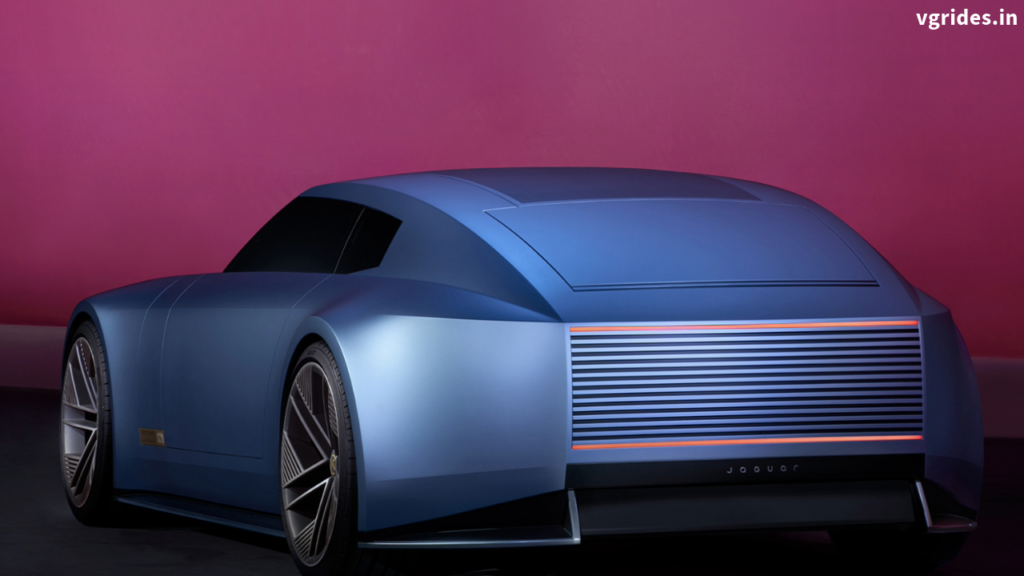 "The Jaguar Type 00 concept car showcasing its long bonnet, sweeping roofline, and 23-inch alloy wheels under dramatic lighting."