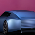 "The Jaguar Type 00 concept car showcasing its long bonnet, sweeping roofline, and 23-inch alloy wheels under dramatic lighting."