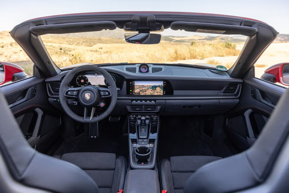Close-up of the Porsche Communication Management (PCM) system in the 2025 Porsche 911 Carrera S, showing Apple CarPlay integration.