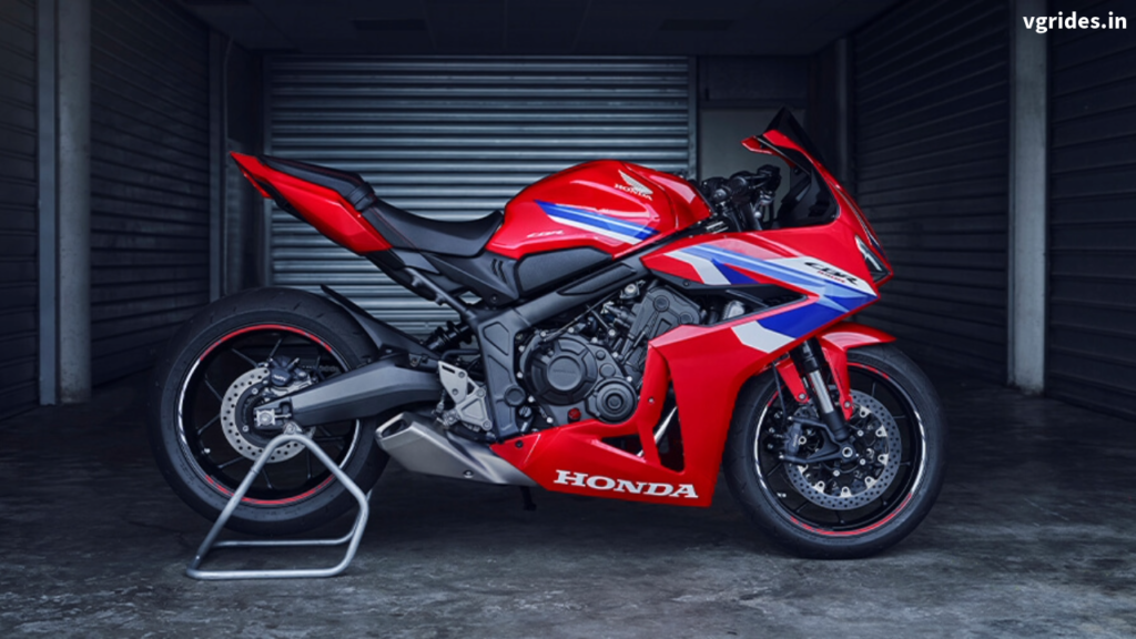 A striking front view of the 2025 Honda CBR650R in Grand Prix Red, showcasing its aggressive design, LED headlights, and aerodynamic styling.
